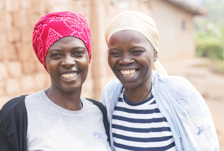 Two artisans smiling at camera