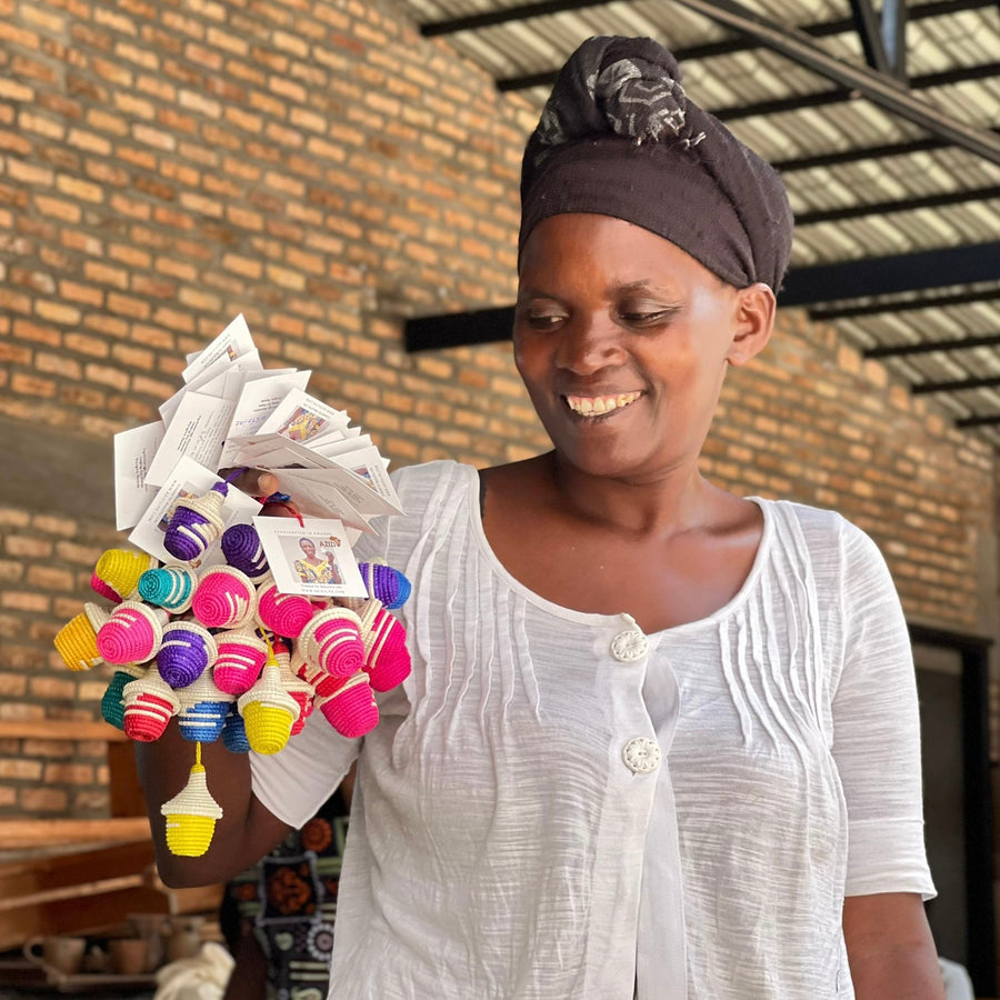 Artisan with mini basket ornaments