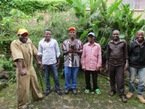 Six men standing in a line and smiling